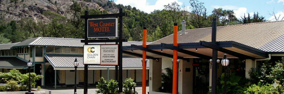West Coaster Motel entrance and sign beneath the Queenstown hills
